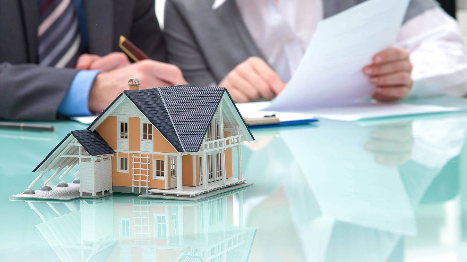 Miniature house model held in hands